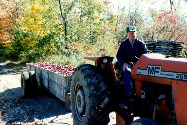 Ed Jensen Jr. riding a tractor